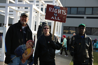 Three men attend the protest in downtown Syracuse. While the protest is called the Women's March, the demonstration was not just for women.